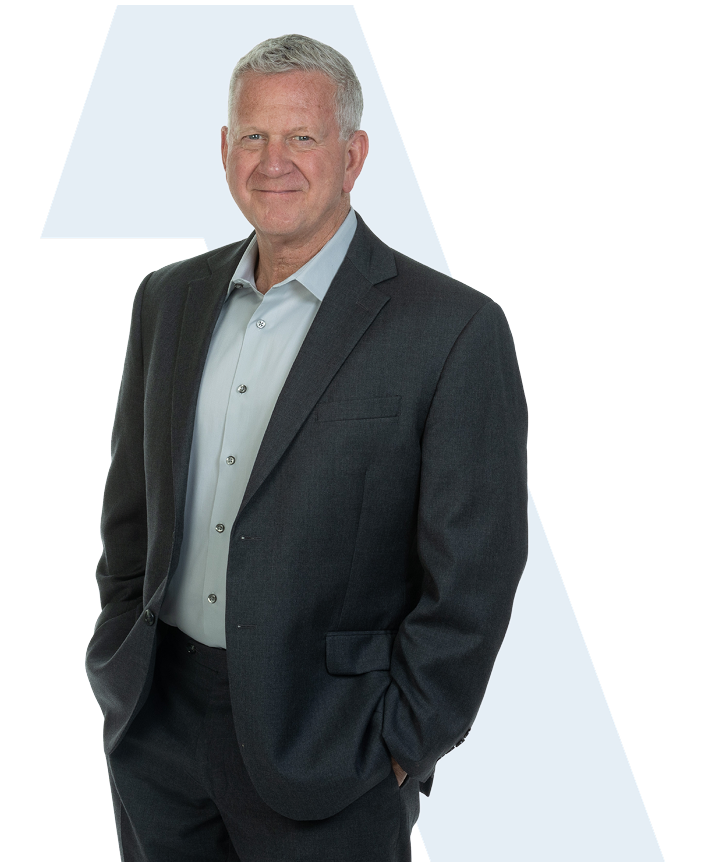 Man in a suit smiling confidently, representing leadership and expertise in the moving industry, aligned with USA Home Listings' mission to support moving companies.