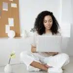 A person using a laptop to look for moving companies